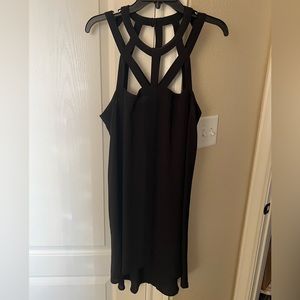 Little black dress. Cage detailing on neckline. Size L. Brand: BCBG Max Azria.